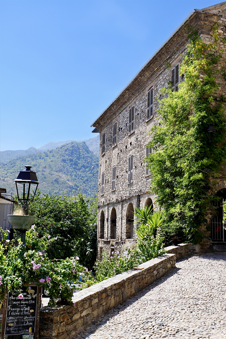 Facade of a Corsican house in the village of Corte. ©2022 Mathieu Improvisato